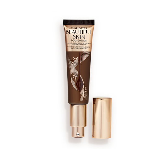 Beautiful Skin Foundation in Shade 17C open An open foundation wand in gold packaging with a pump dispenser and a black-brown-coloured body to show the shade of the foundation inside.