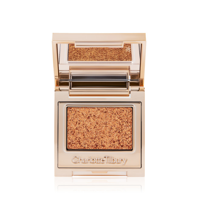 An open, single-pan eyeshadow with a mirrored lid in an iridescent orange-gold shade with very fine shimmer. 