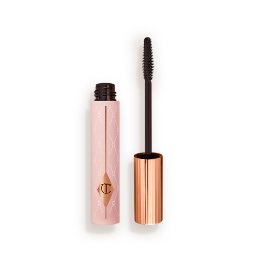 Pillow Talk Mascara open Mascara in a pink-coloured tube with its gold-coloured lid with a black applicator next to it.