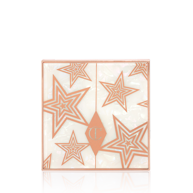 Luxury Palette of Pearls in Celestial Pearl closed Eyeshadow palette's packaging sleeve in a white colour with gold stars printed all over.