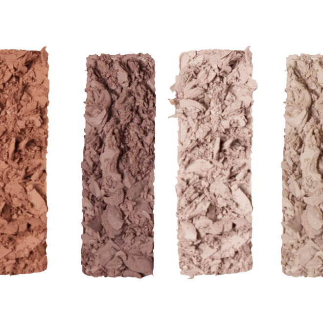 Swatches of six eyeshadows in nude, matte shades of light beige, light sand, fawn, clay-brown, dark brown, and black. 