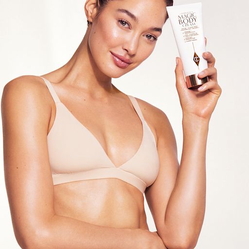 Body Care model shot Model holding Charlotte's Magic Body Cream body moisturiser