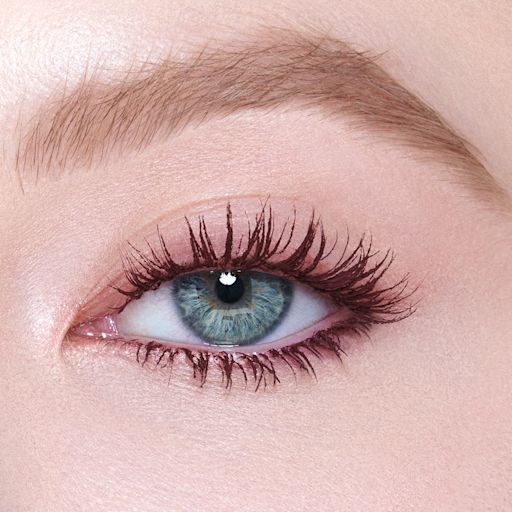 PT - Push Up Lashes Dream Pop Augen schließen Single-eye close-up of a fair-tone model with blue eyes wearing a berry-brown, lengthening mascara that gives her lashes the appearance of false lashes.