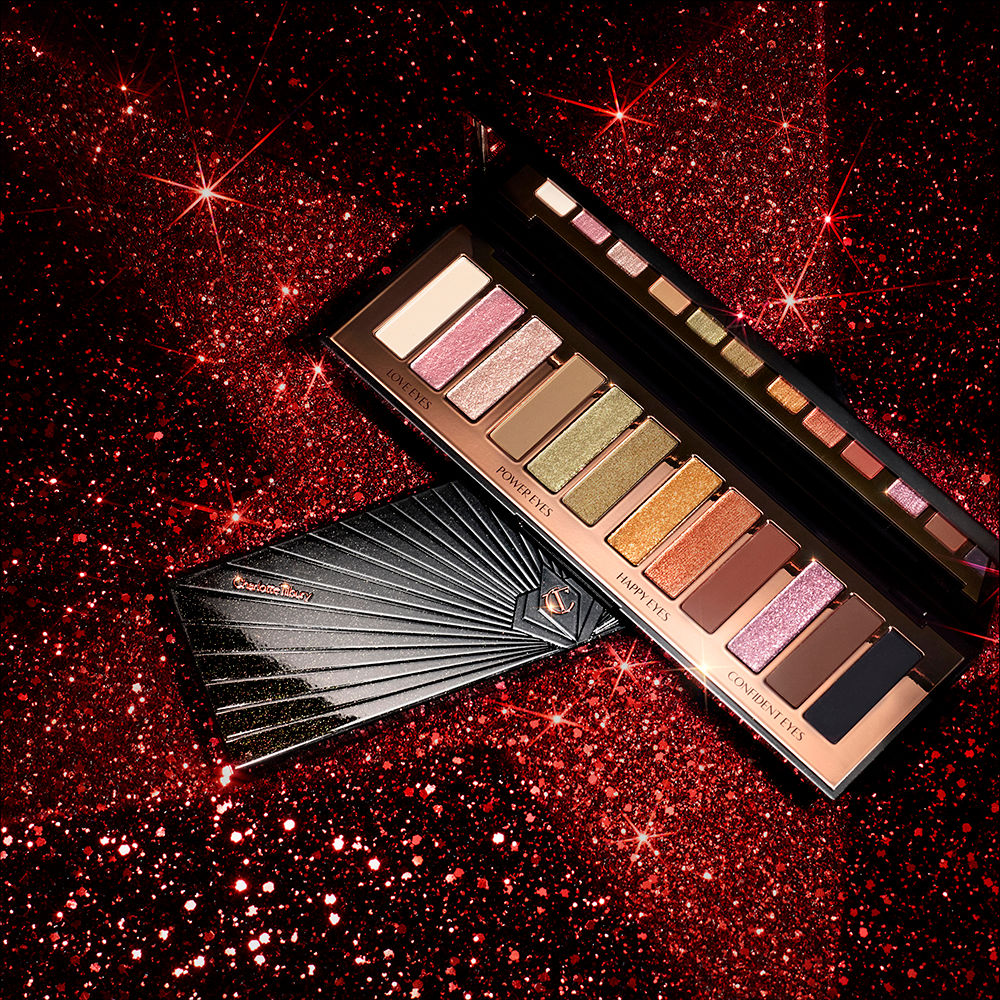 Instant Eye Palette in Smokey Eyes are Forever banner Red and black-coloured galaxy-theme banner with an open and closed, 12-pan eyeshadow palette with matte and shimmery shades in beige, pink, gold, green, brown, peach, and black.