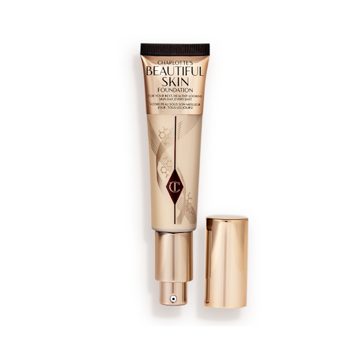 Beautiful Skin Foundation in 2N open An open foundation wand in gold packaging with a pump dispenser and a medium-beige-coloured body to show the shade of the foundation inside.