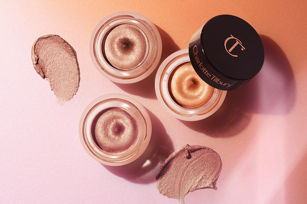 Three, petite, open pots filled with shimmery cream eyeshadows in nude, bronze, and rose gold.