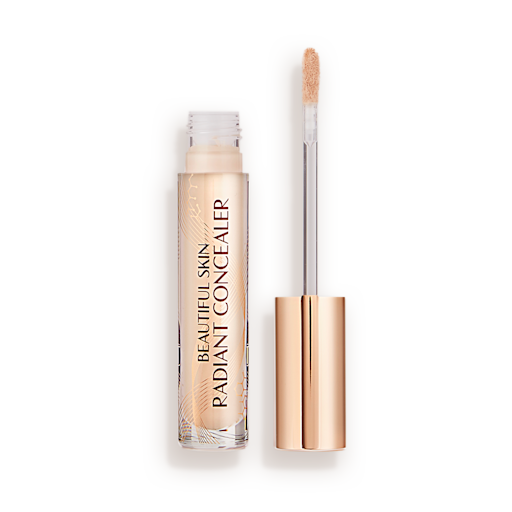Beautiful Skin Radiant in Concealer in 3.5 lid removed Radiant concealer in a glass tube with its doe-foot applicator next to it with a gold-coloured handle.