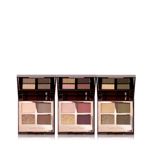 Luxury Palette Eyeshadow Trio open Three, open, quad eyeshadow palettes with mirrored-lids in matte and shimmery gold, beige, brown, red, purple, and green shades.