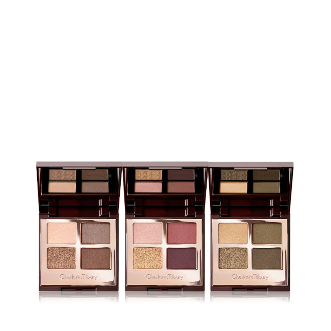 Three, open, quad eyeshadow palettes with mirrored-lids in matte and shimmery gold, beige, brown, red, purple, and green shades.