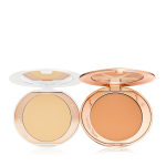 Two, open, setting powder compacts with mirrored-lids and white and gold-coloured packaging, in banana yellow and clay-brown shades.