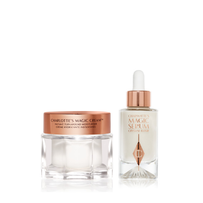 A pearly-white cream in a glass jar with a golden, metallic lid with a pearly white serum in a glass bottle with a rose gold and white dropper. 