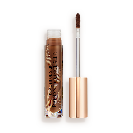 Beautiful Skin concealer in 17 open Dark brown radiant concealer in a glass tube with its gold-coloured lid with a doe-foot end next to it, and text on the tube that reads, 'Beautiful Skin Concealer'
