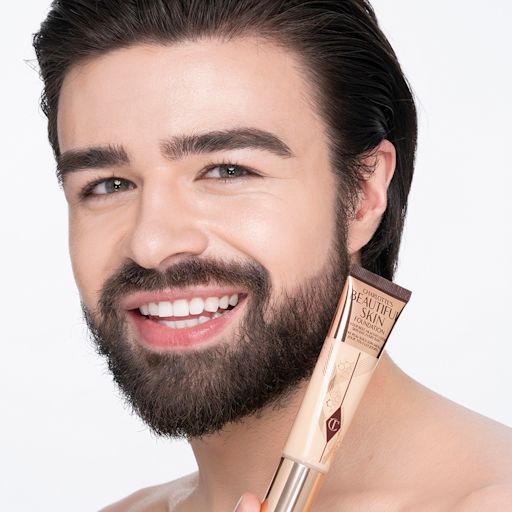 Beautiful Skin Foundation in 3C on light-tone model after application Light-tone brunette male model wearing glowy, skin-like foundation with a satin finish with nude lipstick and subtle eye makeup.