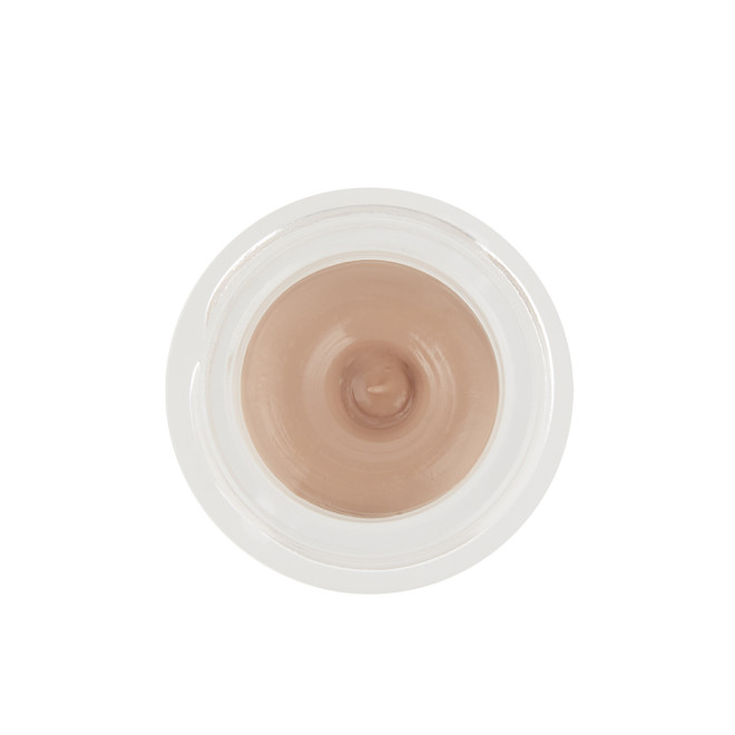 An open frosted glass pot with a cream eyeshadow in a nude cashmere shade.