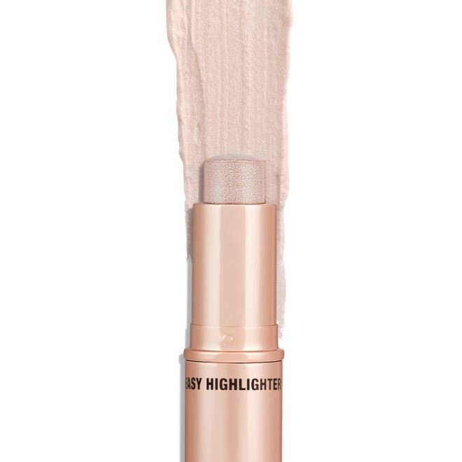 An open, highlighter stick in soft opal colour with a golden-coloured tube.