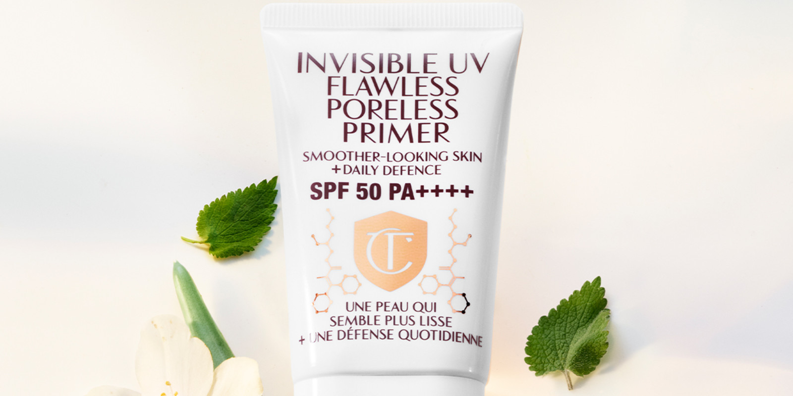 Close-up of a primer in a white-coloured tube with a white-coloured lid with text on it that reads, 'invisible UV Flawless poreless primer SPF 50 PA++++'.