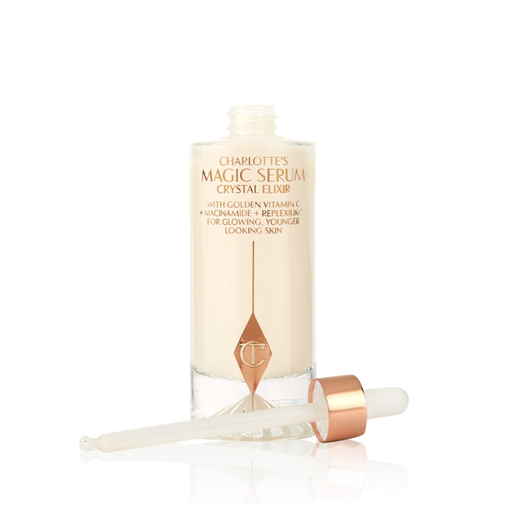Magic Serum open A luminous, ivory-coloured facial serum in a glass bottle with a white and gold-coloured dropper lid