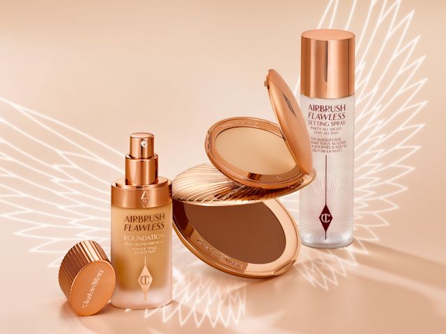 The Airbrush Collection banner Banner with a collection of makeup that includes a setting spray, setting powder compact, foundation in a frosted glass bottle with a pump dispenser, and a bronzer compact, all in sleek, gold-coloured packaging