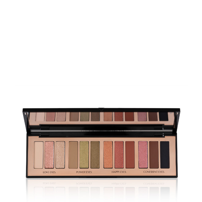 An open, 12-pan eyeshadow palette with matte and shimmery shades in beige, pink, gold, green, brown, peach, and black.