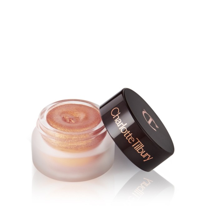 A golden pink duo-chrome-effect cream eyeshadow with a duo-chrome metallic finish in a petite, open glass pot with a dark brown lid.