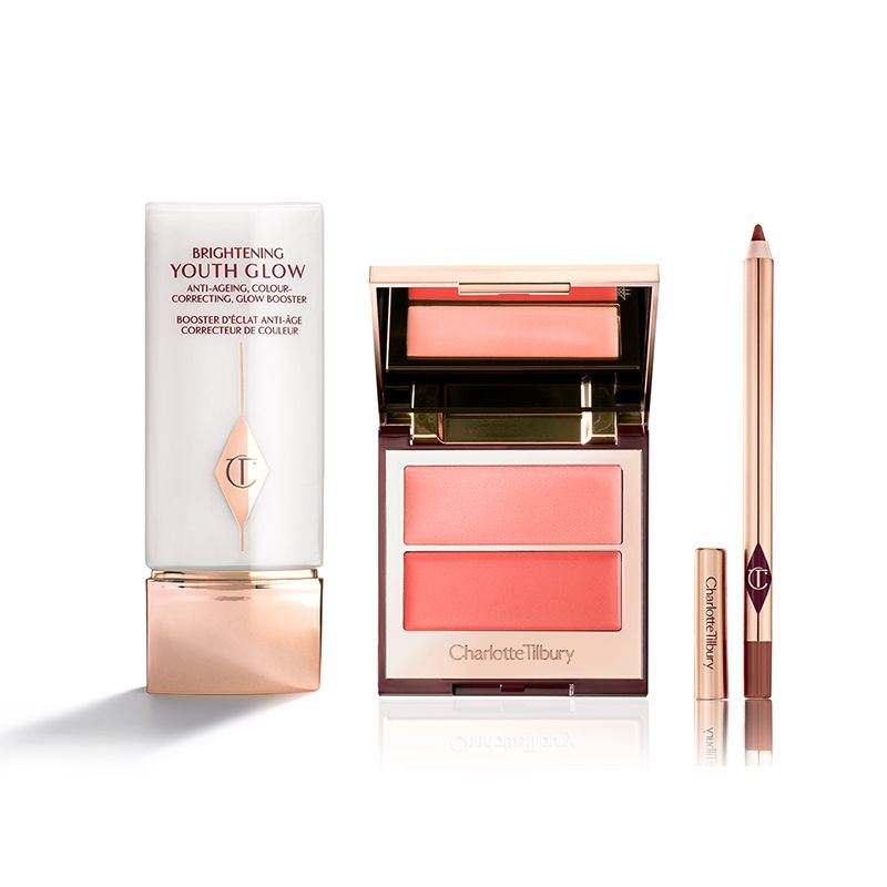 A colour-correcting primer in white and champagne-coloured packaging, a two-tone blush in coral pink, and a lip liner pencil in taupe-brown.