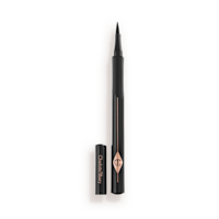 Feline Flick Eyeliner pen in Panther open An open eyeliner pen in jet-black packaging with the iconic CT logo embossed on it and its cap next to it.