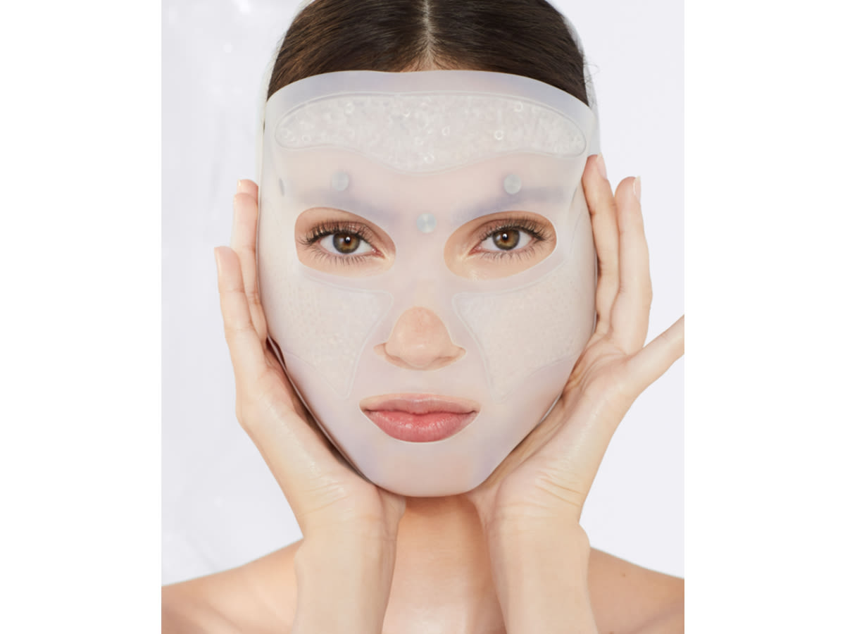 Cryo-Recovery Mask on fair-tone model Fair-tone, brunette model applying a reusable, white-coloured mask, that ensures glowy, flawless, and lifted skin.