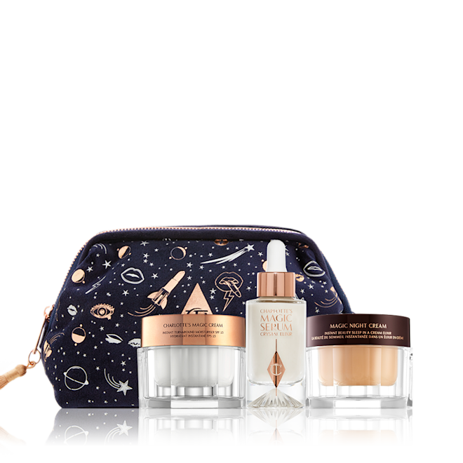 Celestial Skincare kit displayed Pearly-white face cream and dark fawn-coloured night cream in glass jars with a luminous, ivory-coloured serum in a glass bottle with a dropper lid along with a avy blue makeup bag with the iconic CT logo in the middle and galaxy-theme illustrations printed all over the bag in white and gold colour.
