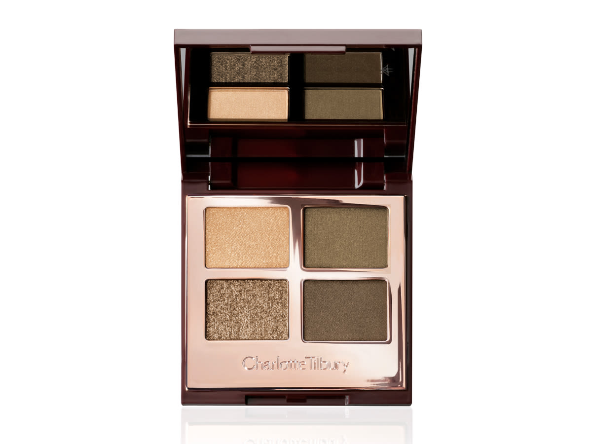 Luxury Palette in The Rebel lid open An open, quad eyeshadow palette in rose gold, metallic packaging with a mirrored lid having dark green, olive green, khaki, and golden eyeshadows.