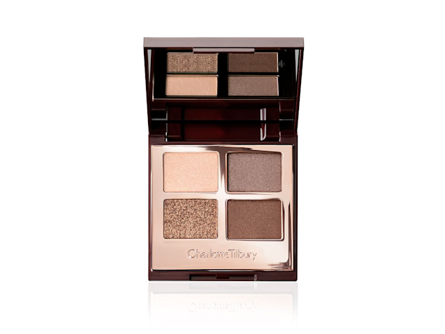 The Golden Goddess Luxury Palette open An open, mirrored-lid eyeshadow palette in matte and shimmery gold, brown, and beige shades,