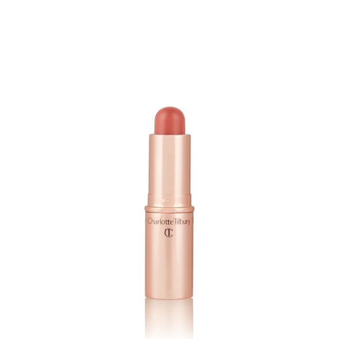An open, lip and cheek colour stick in a glowy nude rose shade in a golden-coloured tube.