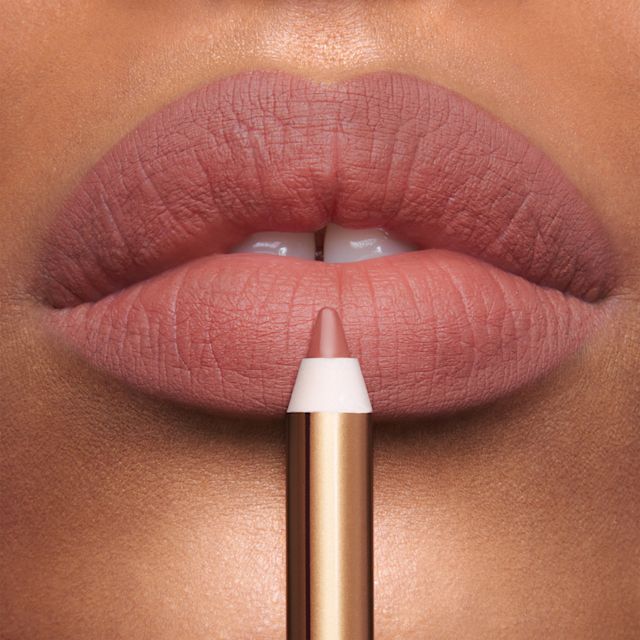 Lip liner application Model close up applying nude-rose Lip Cheat lip liner in Icon Baby