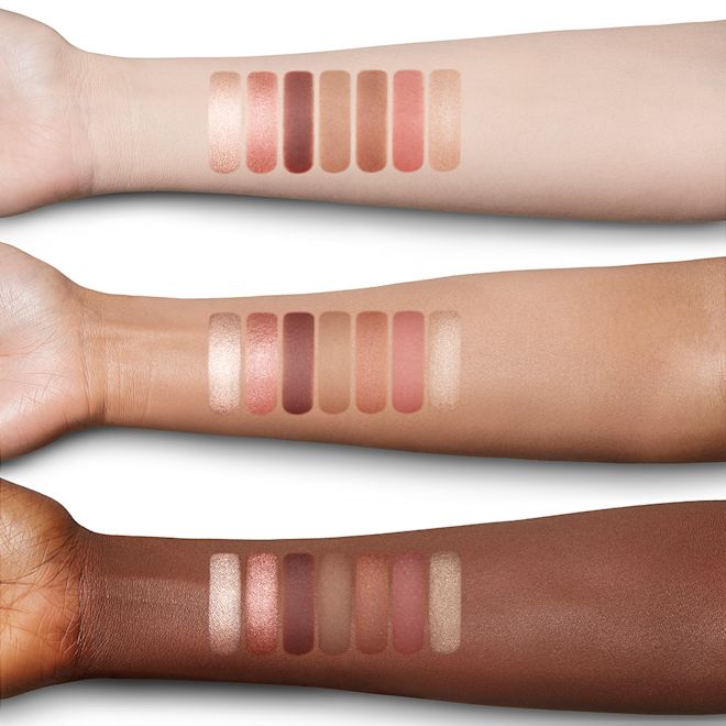 Instant Look in a Palette in Sunset Dreamscape arm swatches Fair, tan, and deep-tone arms with swatches of a face palette with three rose gold, dusky pink, and plum-coloured eyeshadows, two blushes in soft peach and medium-pink, light brown bronzer, and soft, gold-coloured highlighter.