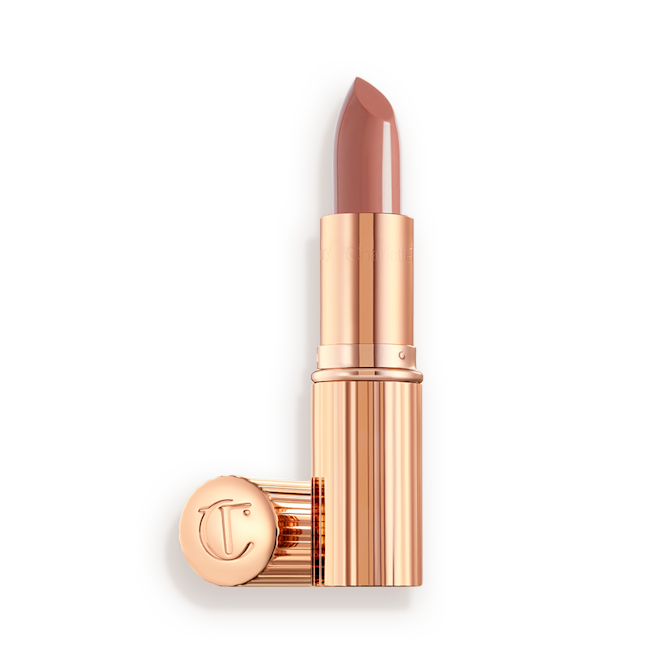 K.I.S.S.I.N.G. in Runway Royalty with and without lid two lipsticks, with and without lid, in soft rosy peach shade with a satin finish in sleek gold-coloured packaging.