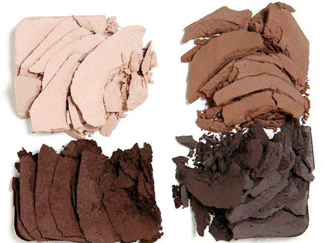 The Sophisticate palette swatches Swatches of four eyeshadows in shades of cream, light brown dark brown, and grey-brown.