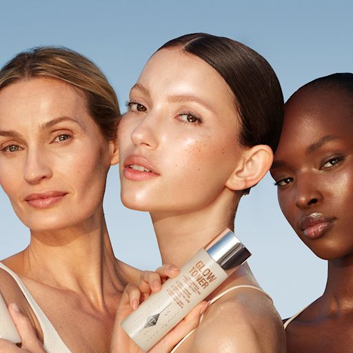 Glow toner on models trio Fair, light, and deep-tone models with glowy, luminous skins holding up a bottle of toner in a clear bottle with a silver-coloured lid.