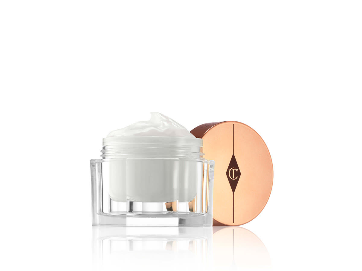 Magic Cream open An open glass jar filled with a pearly-white face cream with its rose-gold-coloured lid next to it.