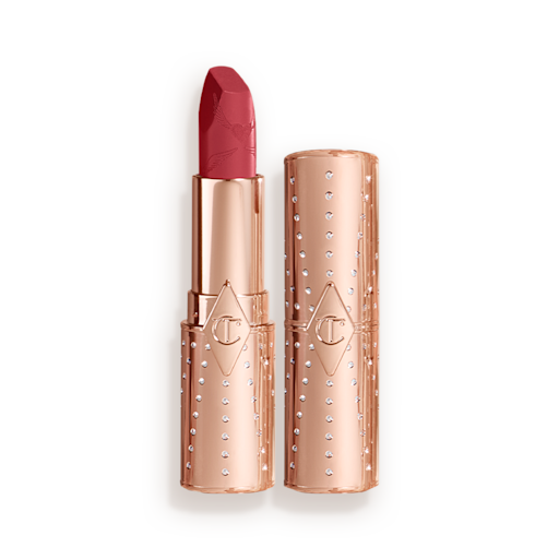 Look of Love Matte Revolution Lipstick in First Dance open An open, blushed berry-rose lipstick in a metallic, golden-coloured tube with its lid next to it.