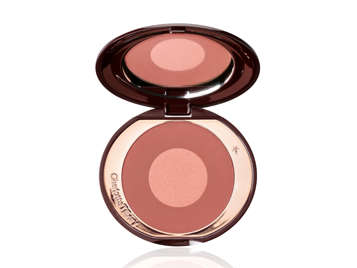 Cheek to Chic in Pillow Talk Intense open An open, mirrored lid, two-tone powder blush in berry pink and rose gold shades.