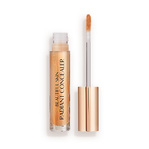 Beautiful Skin Radiant in Concealer in 11.5 lid removed Radiant concealer in a glass tube with its doe-foot applicator next to it with a gold-coloured handle.