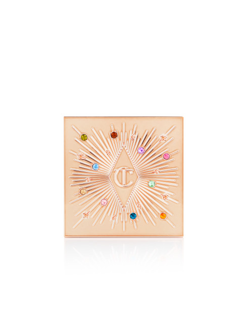 A closed, one-pan eyeshadow compact in light golden colour with colourful stones all over the lid.