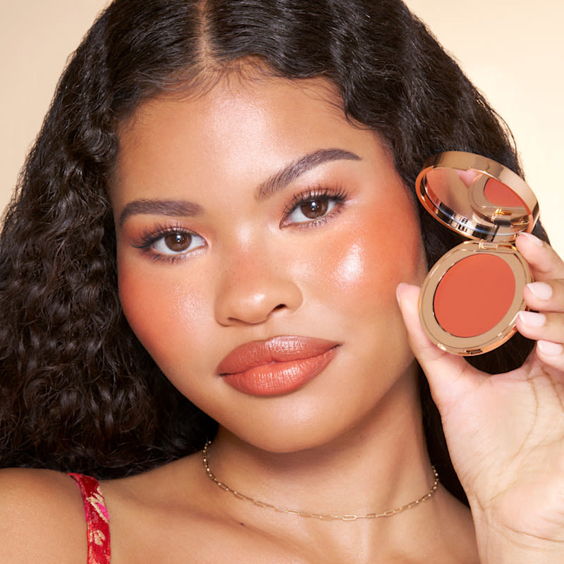 Sunset Bronze model shot Model wearing a terracotta summer blush look created with Sunset Bronze Glow