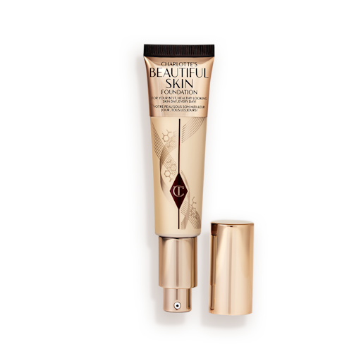 Beautiful Skin Foundation in 2W open An open foundation wand in gold packaging with a pump dispenser and a medium-beige-coloured body to show the shade of the foundation inside.
