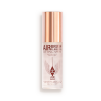 Airbrush Flawless Setting Spray closed A closed, travel-size setting spray in a clear bottle with a gold-coloured lid.