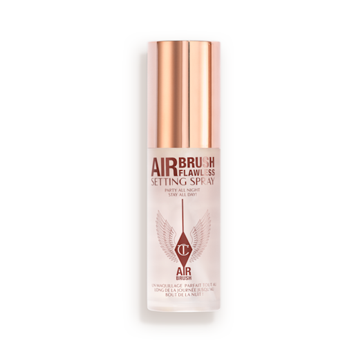 Airbrush Flawless Setting Spray closed A closed, travel-size setting spray in a clear bottle with a gold-coloured lid.