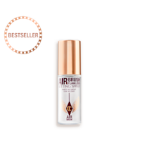 Airbrush Flawless Setting Spray closed A closed, travel-size setting spray in a clear bottle with a gold-coloured lid.