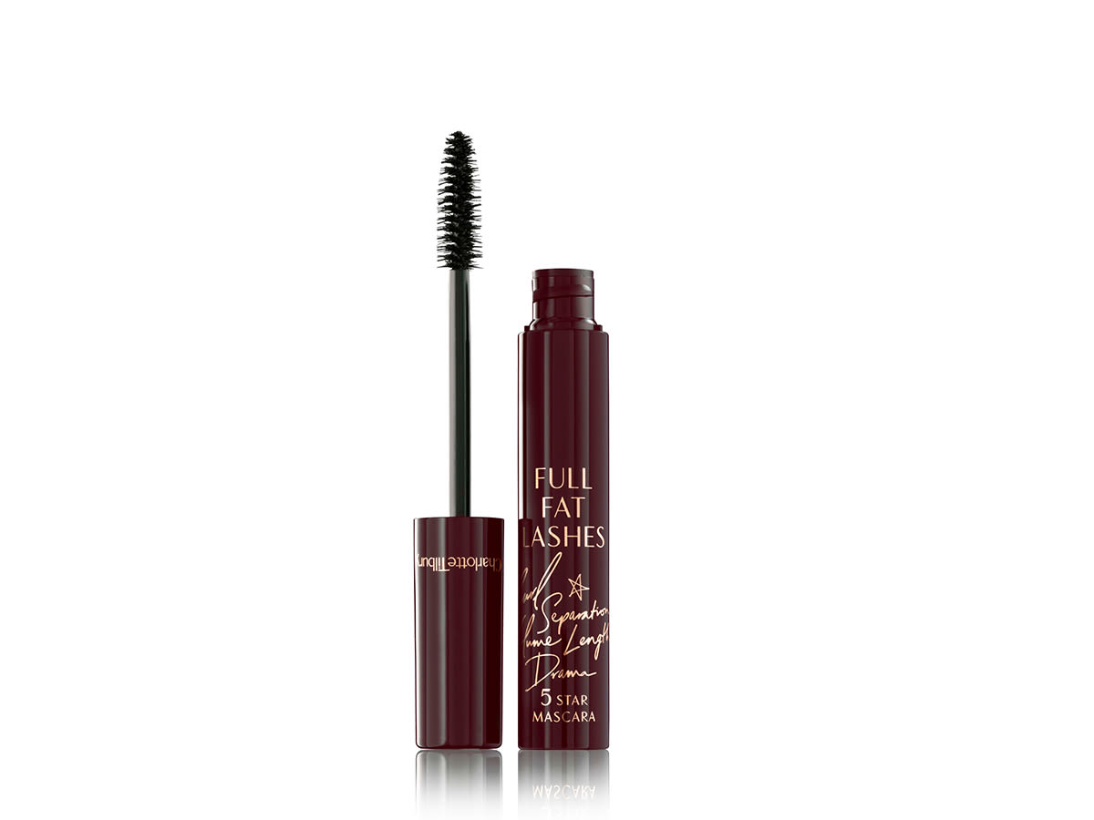 Full Fat Lashes open Black, glossy mascara in an open, dark burgundy tube with the applicator next to it.