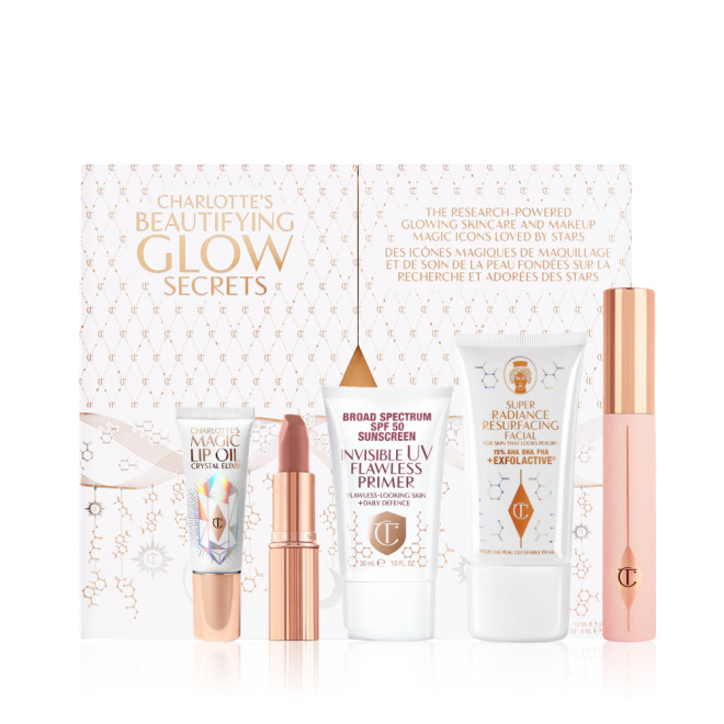 Lip oil in a white-coloured tube with a gold-coloured lid, nude pink matte lipstick in gold-coloured tube, SPF-infused primer in a white-coloured tube, exfoliating wash-off mask in a white-coloured tube, mascara in pink-coloured tube with gold-coloured lid. 