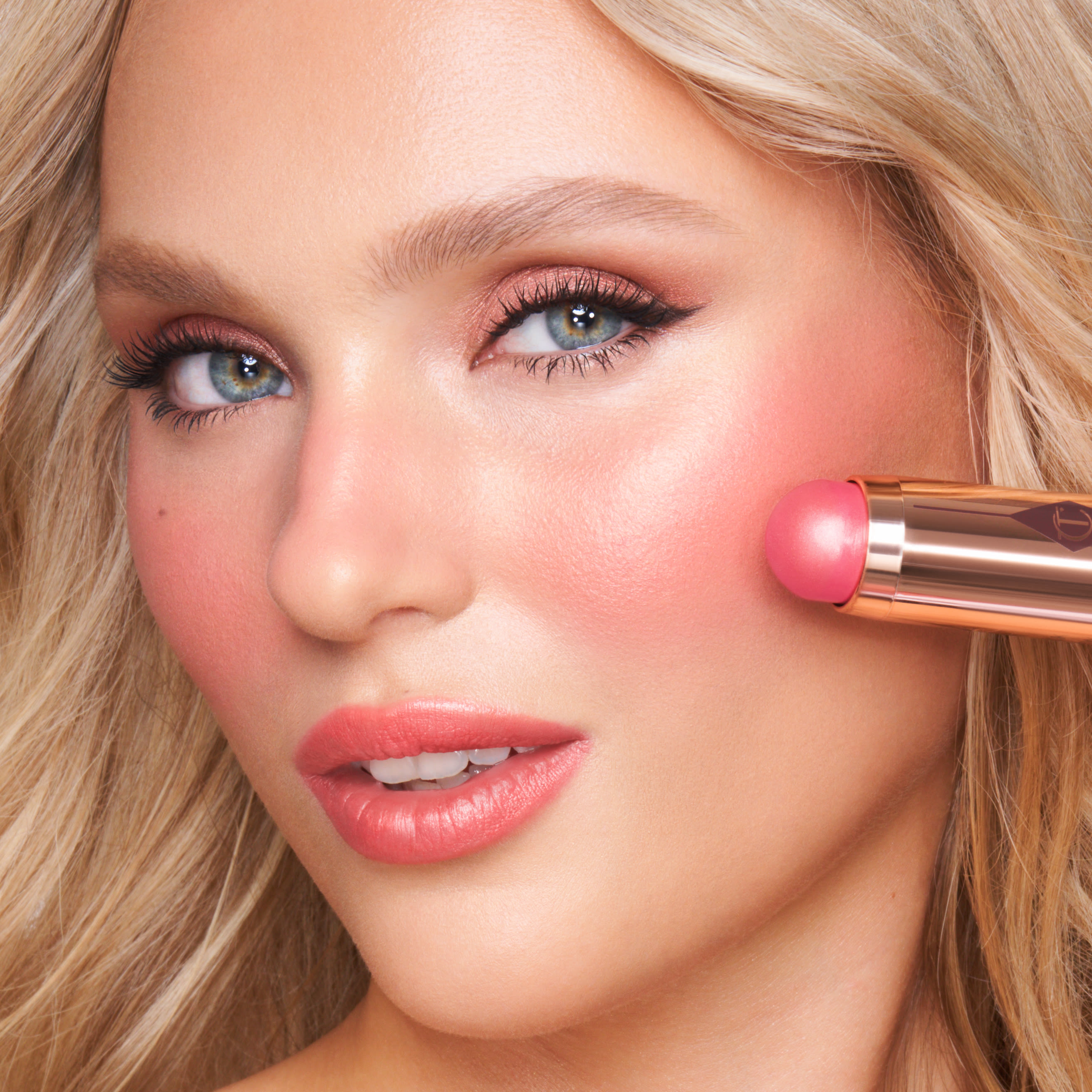 Beach Wedding Makeup model shot Model wearing a beach wedding makeup look and holding Beach Sticks Las Salinas cream blush