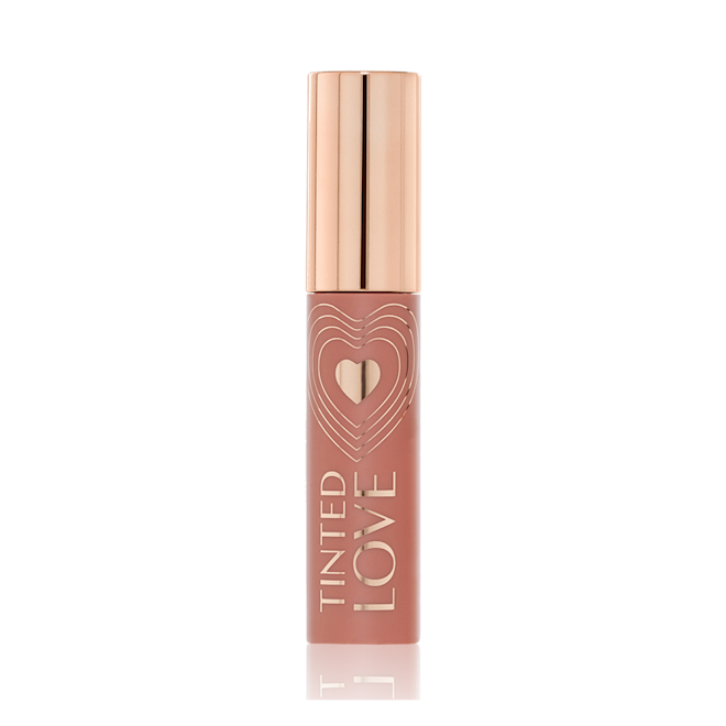 Tinted Love Lip and Cheek Tint in Blushed Rose closed A closed tube of lip and cheek tint in a sheer, tea rose colour with a gold-coloured lid.